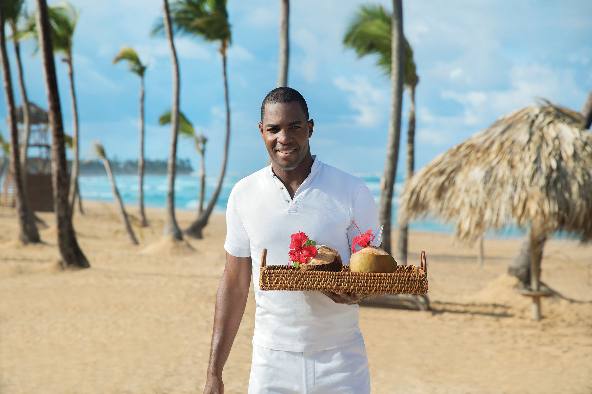 Couple Drinking Coconut Cocktails on the Beach